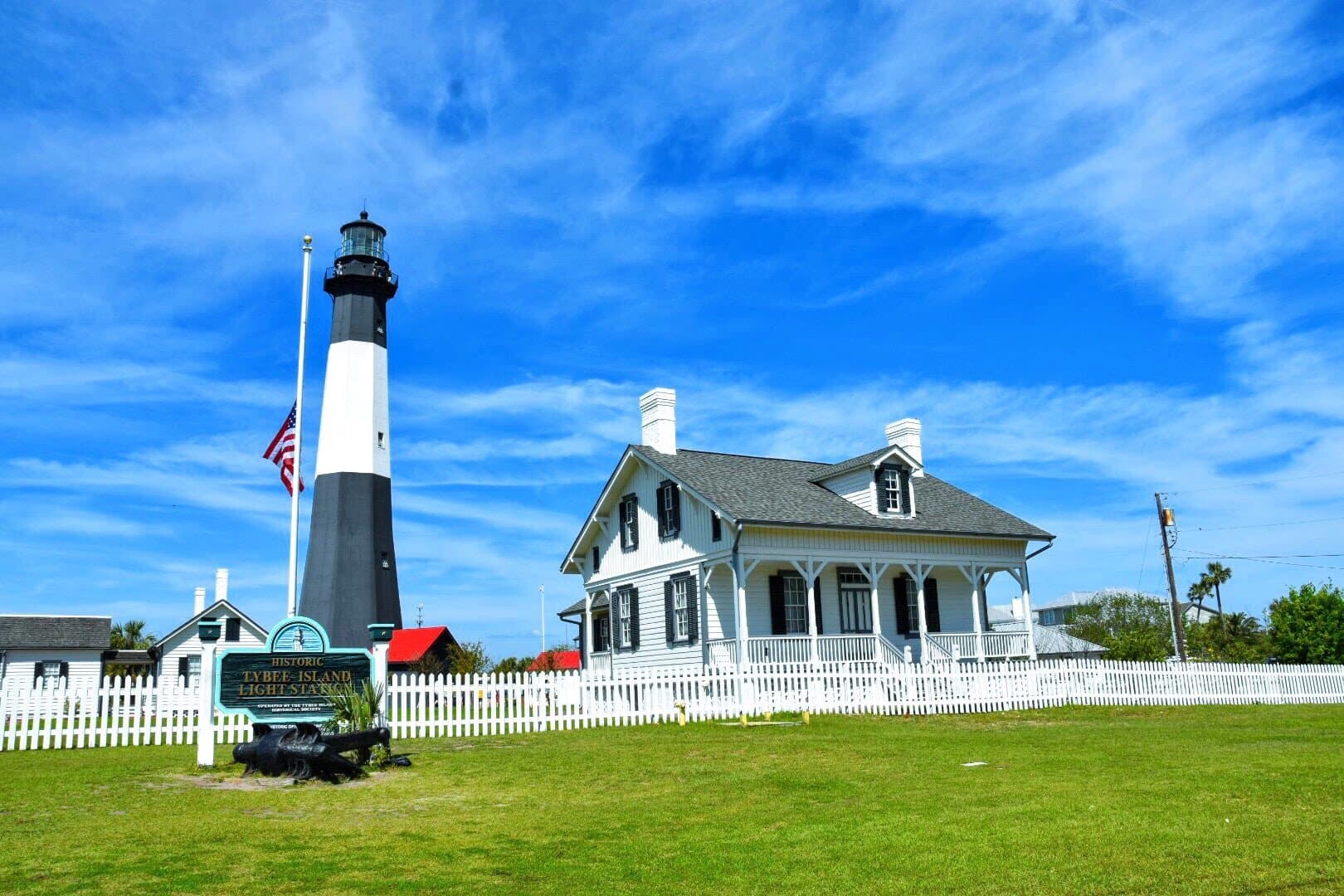 The black-and-white Tybee Island lighthouse against a blue sky